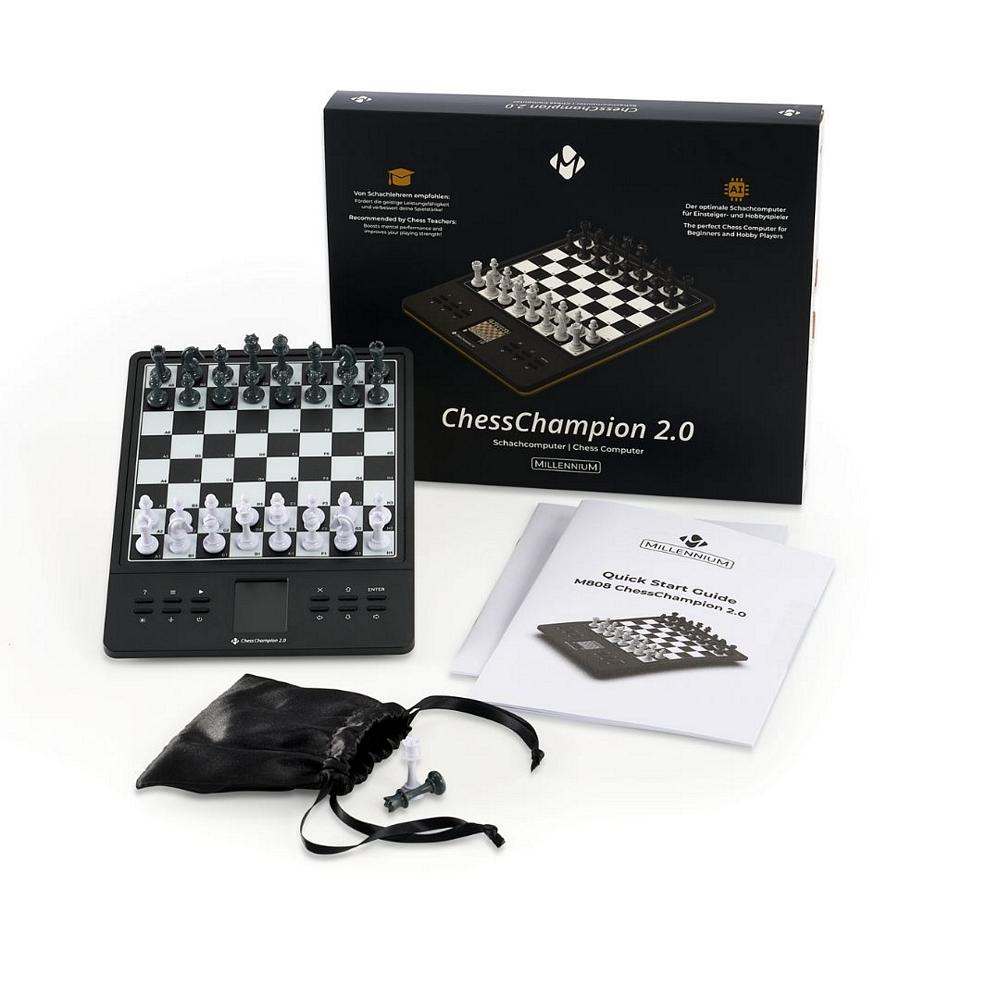 Hele indholdet af ChessChampion 2.0: skakcomputeren, produktæsken (emballagen), manualen og posen med brikker.